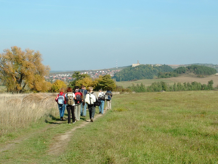 Hiker team walks on the tracks towards the Castle of Nógrád