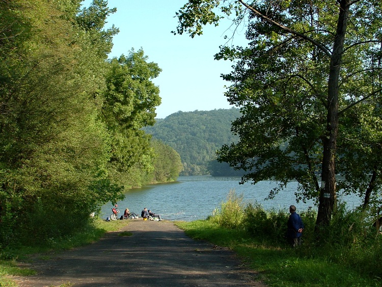 The old asphalt road disappears unter the surface of the lake