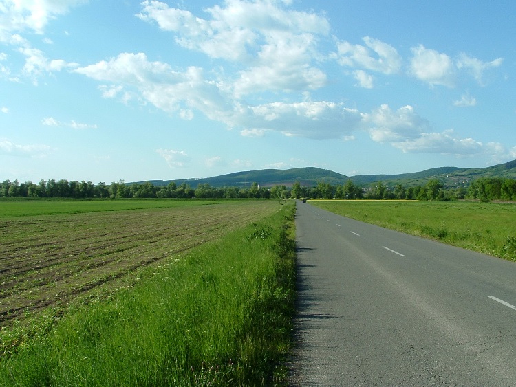 Asphalt road leads on the plain of Sajó River towards Putnok and the hills