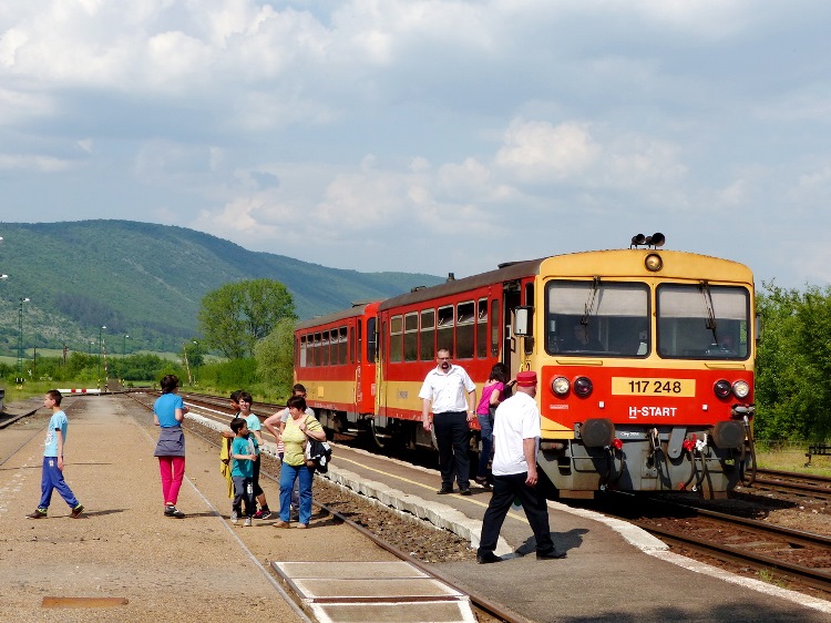 Arriving train at Bódvaszilas railway station. The last ridge of Aggtelek Hills stands in the background.